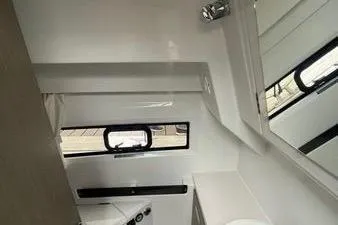  Yacht Photos Pics Interior of 2024 Jeanneau Merry Fisher 895 boat, featuring sleek white design and window.
