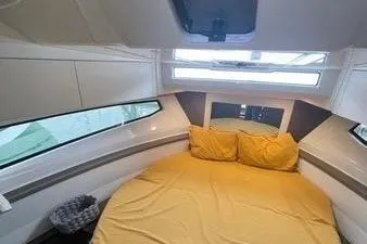  Yacht Photos Pics 2024 Jeanneau Merry Fisher 895 cabin with yellow bedding and modern interior design.
