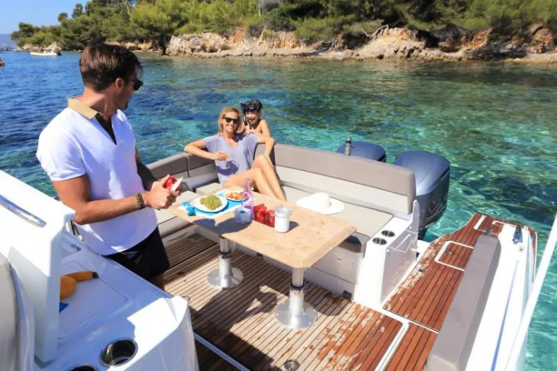 Sabinal Yacht Photos Pics Manufacturer Provided Image: People enjoying a meal on a 2019 Jeanneau Leader 10.5 boat in clear waters.