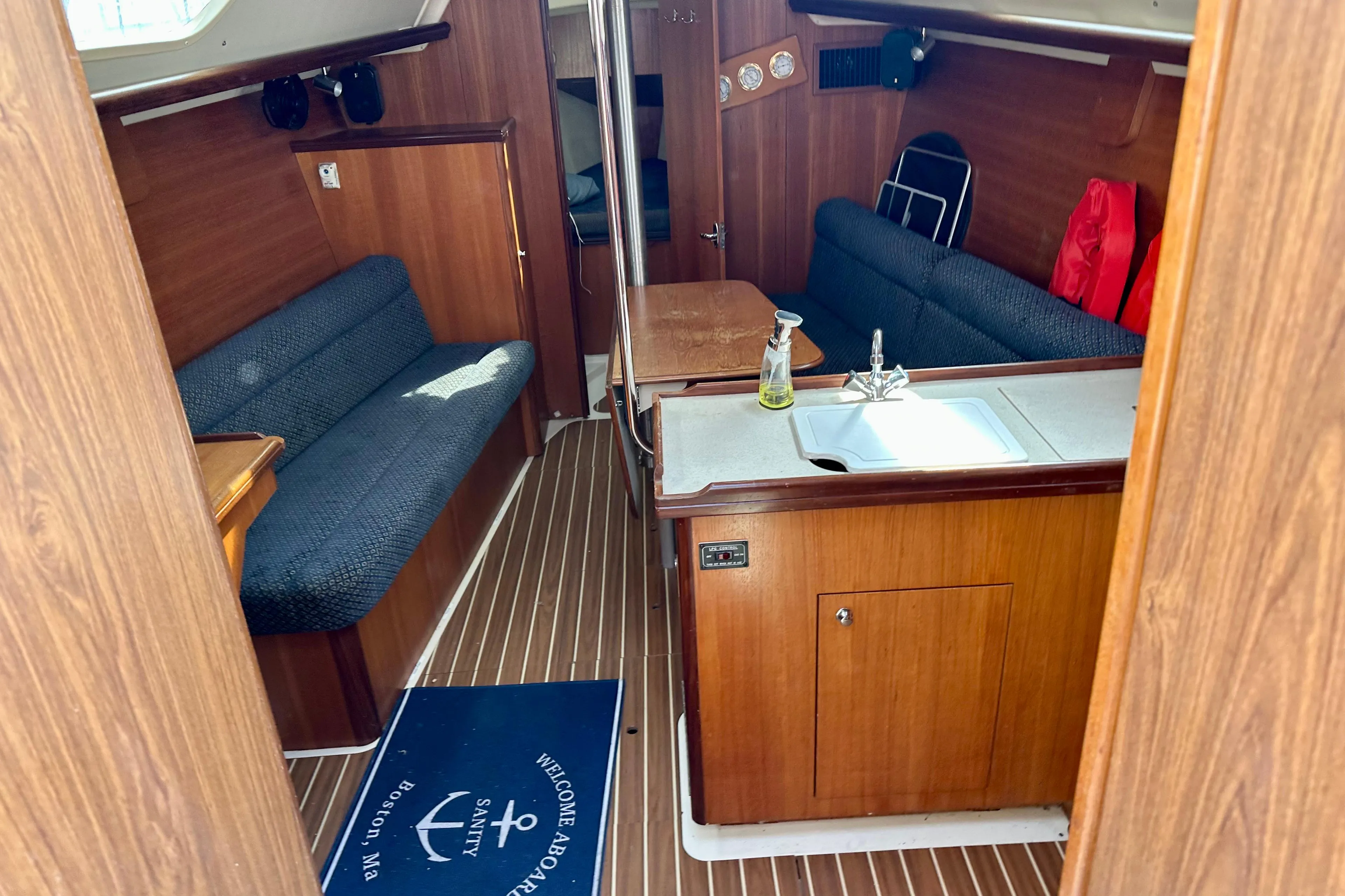 Interior of a 2006 Hunter 31 sailboat with wood finish and seating area.