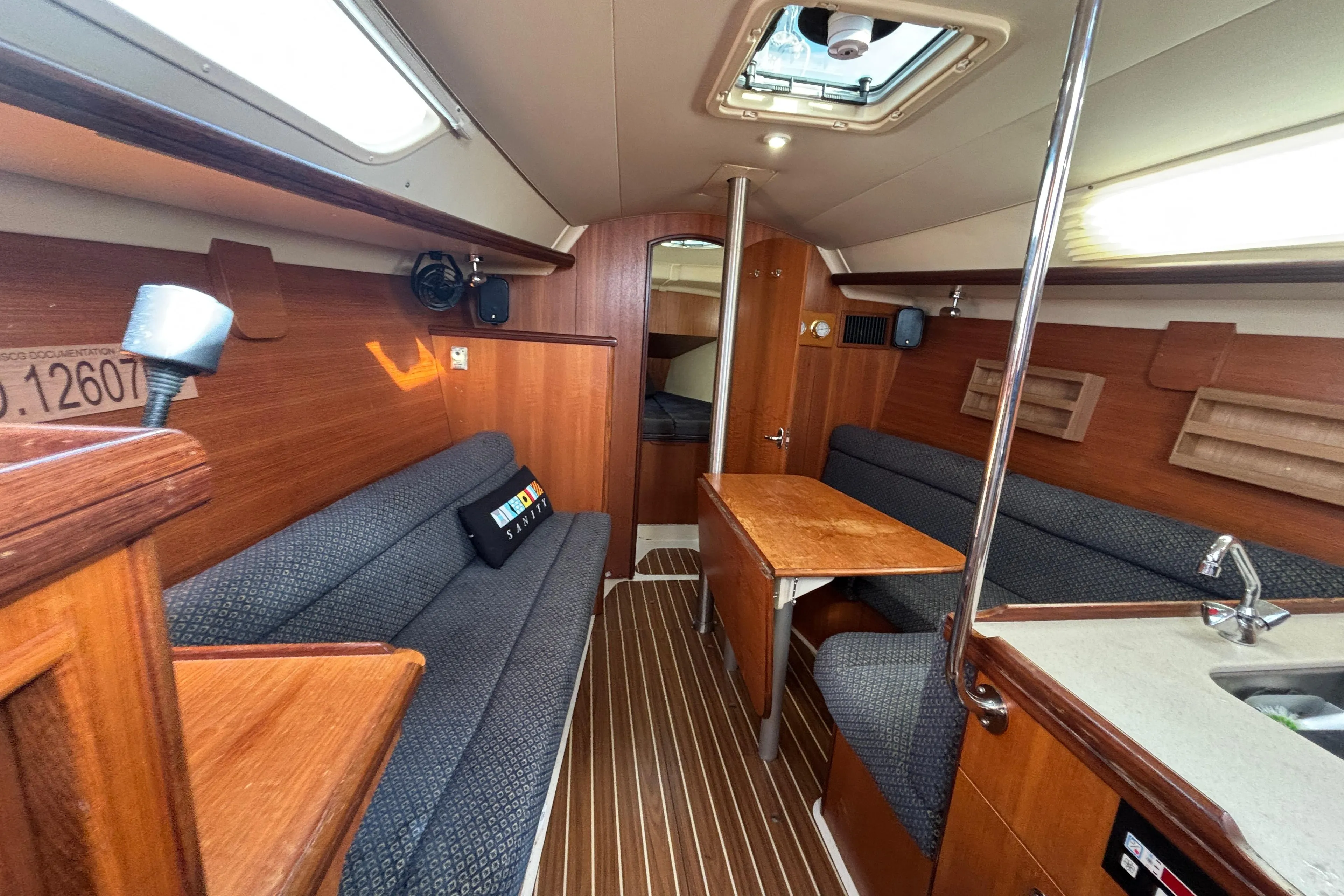 Interior of a 2006 Hunter 31 sailboat with wood finish and seating area.