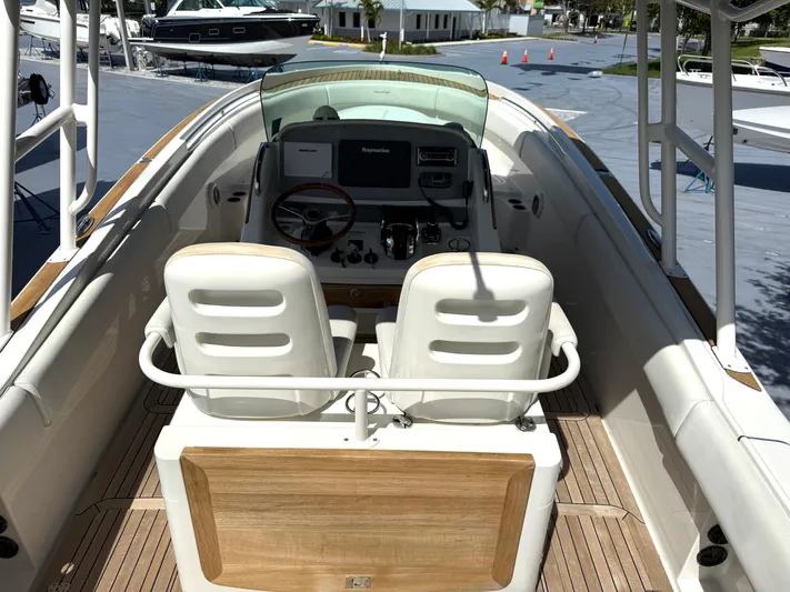 Stop Talking Yacht Photos Pics 2014 Chris-Craft Catalina 29 boat interior with dual seats and steering console.