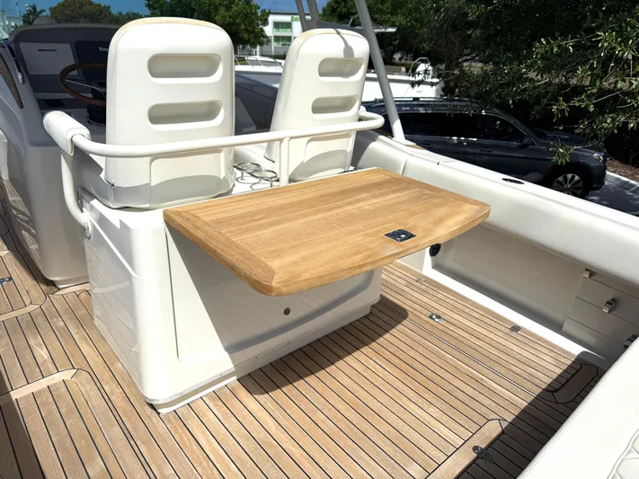 Stop Talking Yacht Photos Pics 2014 Chris-Craft Catalina 29 boat interior with wooden deck and seating area.
