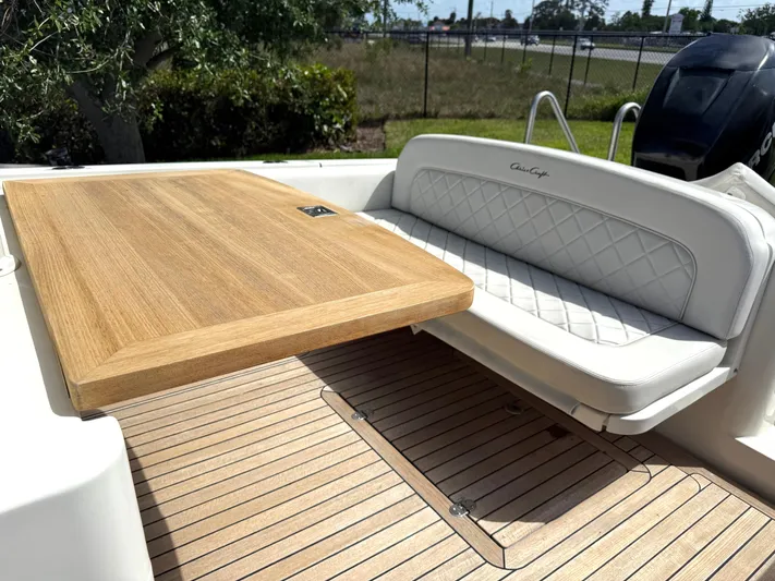 Stop Talking Yacht Photos Pics 2014 Chris-Craft Catalina 29 boat with teak table and cushioned seating.