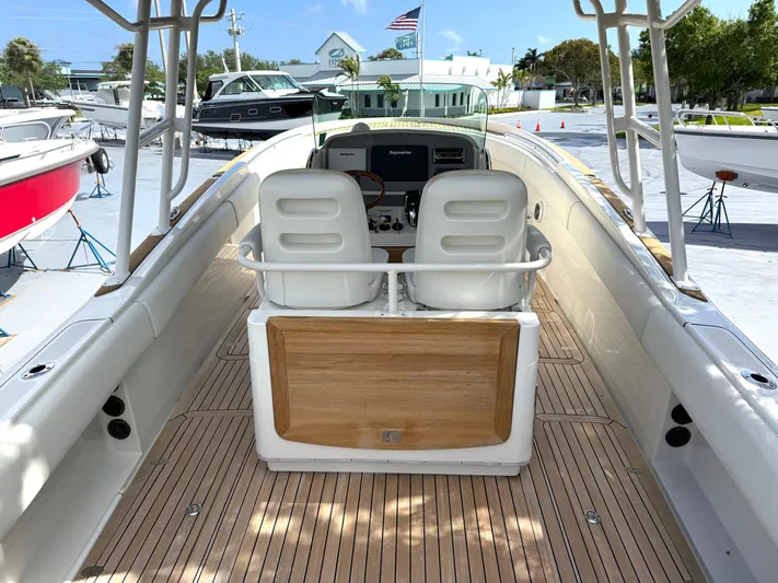 Stop Talking Yacht Photos Pics 2014 Chris-Craft Catalina 29 boat interior with dual seats and wooden deck.