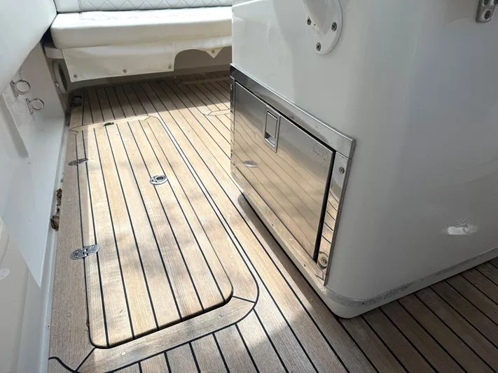 Stop Talking Yacht Photos Pics 2014 Chris-Craft Catalina 29 interior with teak flooring and stainless steel storage.