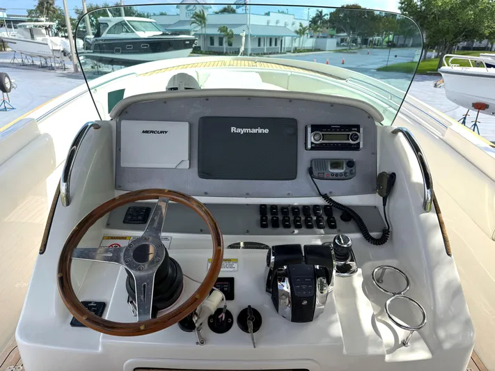 Stop Talking Yacht Photos Pics 2014 Chris-Craft Catalina 29 helm with Raymarine electronics and wooden steering wheel.