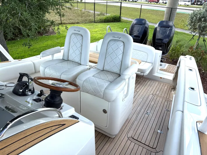 Stop Talking Yacht Photos Pics 2014 Chris-Craft Catalina 29 boat interior with white seating and wooden accents.