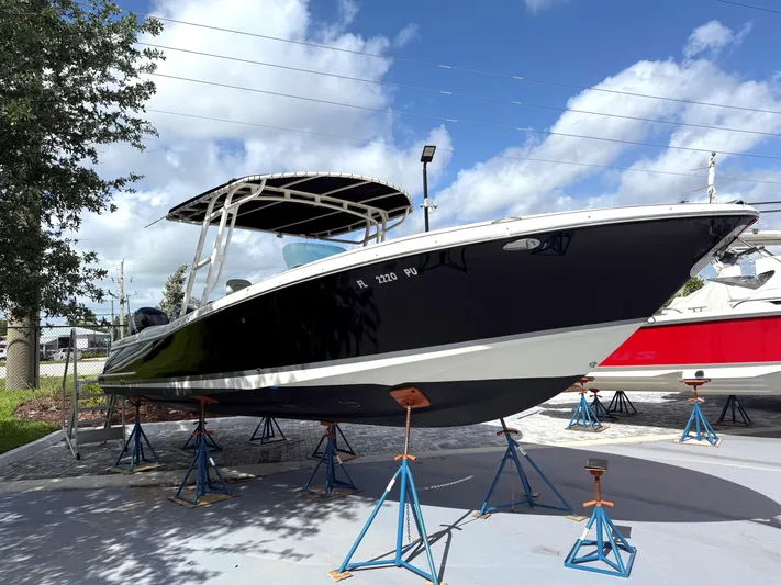 Stop Talking Yacht Photos Pics 2014 Chris-Craft Catalina 29 boat on stands, under a clear blue sky.