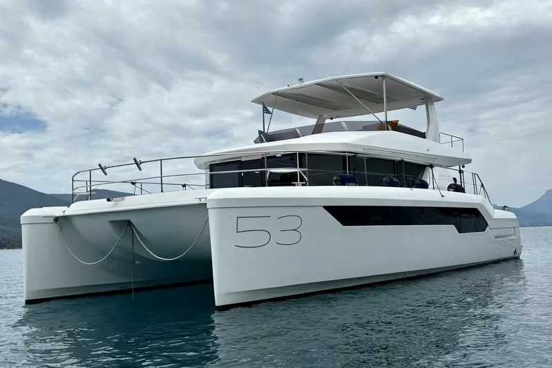  Yacht Photos Pics 2023 Leopard 53 Powercat yacht on calm water under cloudy sky.