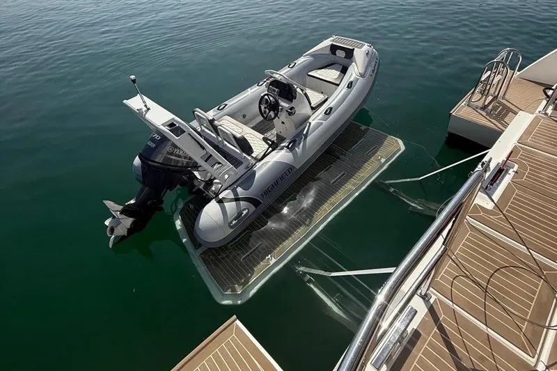  Yacht Photos Pics 2023 Leopard 53 Powercat with tender on hydraulic platform in calm water.