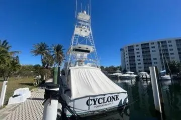 Cyclone Yacht Photos Pics 1996 Buddy Davis 67 yacht docked, sunny day, palm trees, waterfront building.