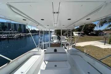 Cyclone Yacht Photos Pics 1996 Buddy Davis 67 yacht, spacious deck view, docked near waterfront properties.