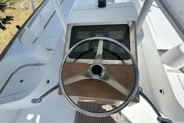 Cyclone Yacht Photos Pics Steering wheel of a 1996 Buddy Davis 67 yacht, showcasing classic design and controls.