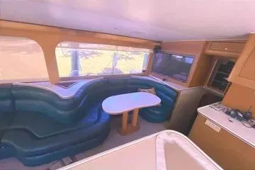 Cyclone Yacht Photos Pics Interior of 1996 Buddy Davis 67 yacht with curved seating and dining table.