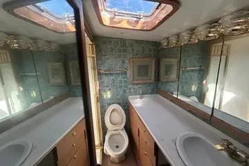 Cyclone Yacht Photos Pics Bathroom interior of 1996 Buddy Davis 67 yacht with skylight and mirrored cabinets.