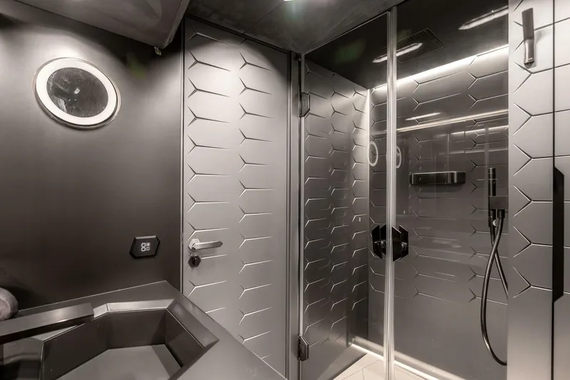 Aspen And Delilah Yacht Photos Pics Luxurious bathroom interior of 2023 Tecnomar 63 Lamborghini yacht, featuring sleek modern design.