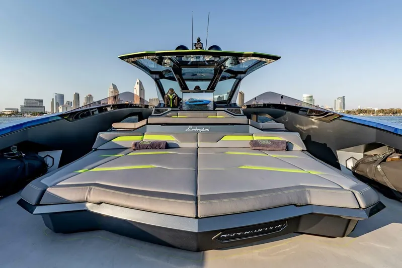 Aspen And Delilah Yacht Photos Pics Luxury Tecnomar 63 Lamborghini yacht, 2023 model, with sleek design and city skyline backdrop.
