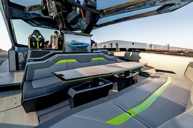 Aspen And Delilah Yacht Photos Pics Luxurious interior of 2023 Tecnomar 63 Lamborghini yacht with sleek seating and modern design.