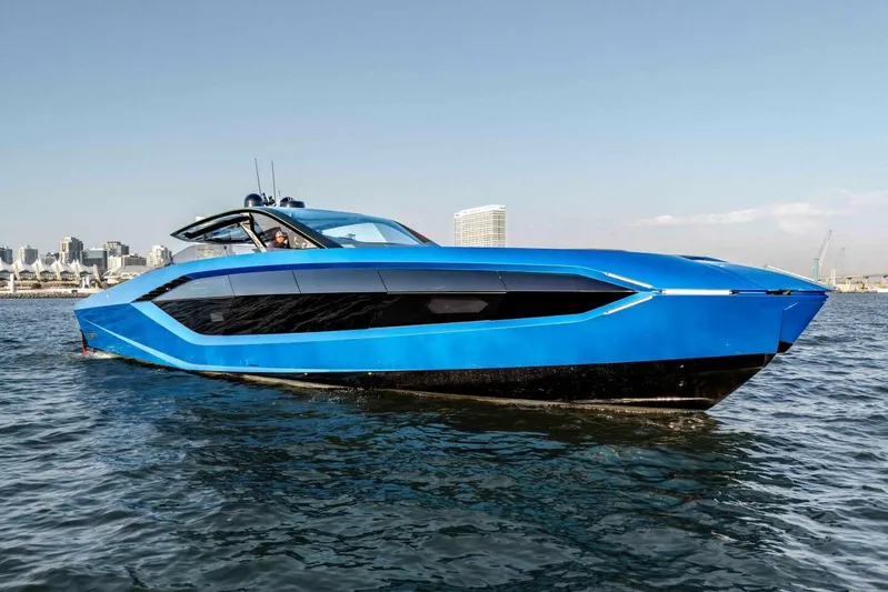 Aspen And Delilah Yacht Photos Pics 2023 Tecnomar 63 Lamborghini yacht in vibrant blue on open water.