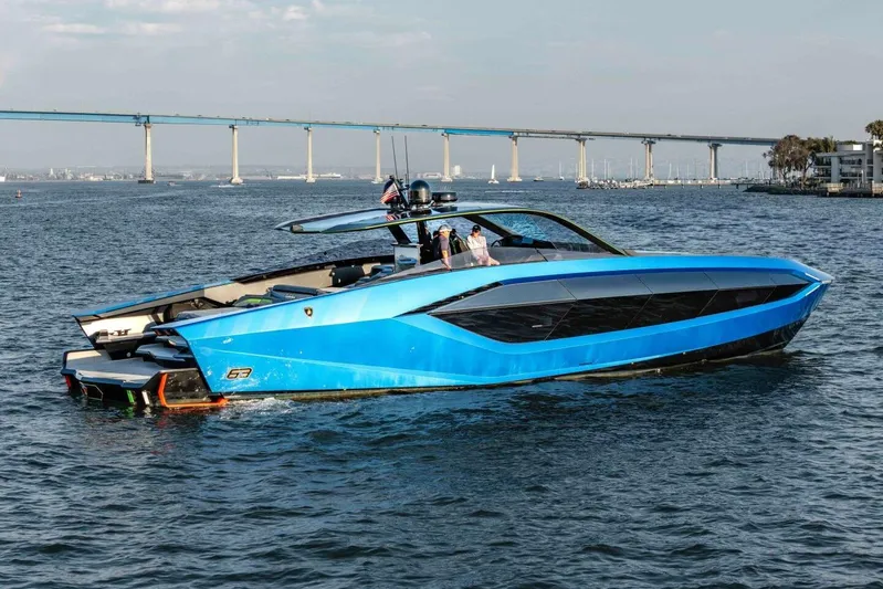 Aspen And Delilah Yacht Photos Pics 2023 Tecnomar 63 Lamborghini yacht in vibrant blue on open water.