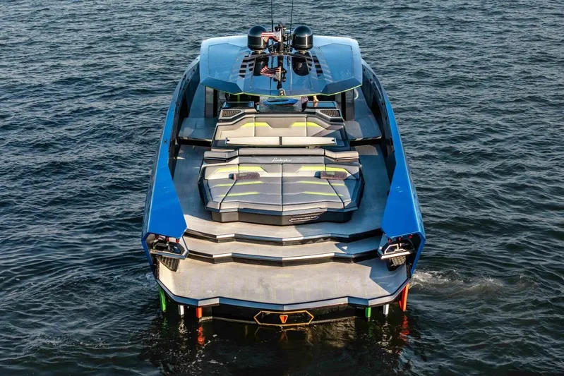 Aspen And Delilah Yacht Photos Pics 2023 Tecnomar 63 Lamborghini yacht on water, showcasing sleek design and luxury features.