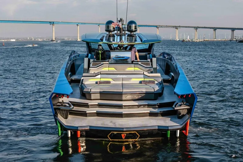Aspen And Delilah Yacht Photos Pics Tecnomar 63 Lamborghini yacht, 2023 model, on water with bridge in background.