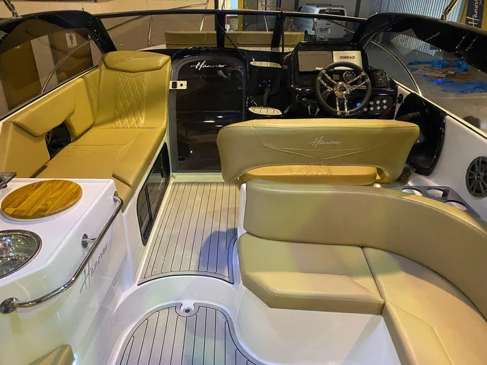  Yacht Photos Pics 2024 Hanover 305 boat interior with beige seating and modern dashboard.