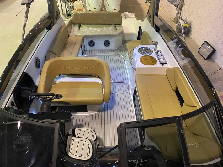  Yacht Photos Pics 2024 Hanover 305 boat interior with tan seating and modern amenities.