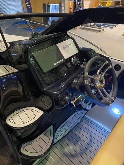  Yacht Photos Pics 2024 Hanover 305 boat dashboard with steering wheel and navigation display.