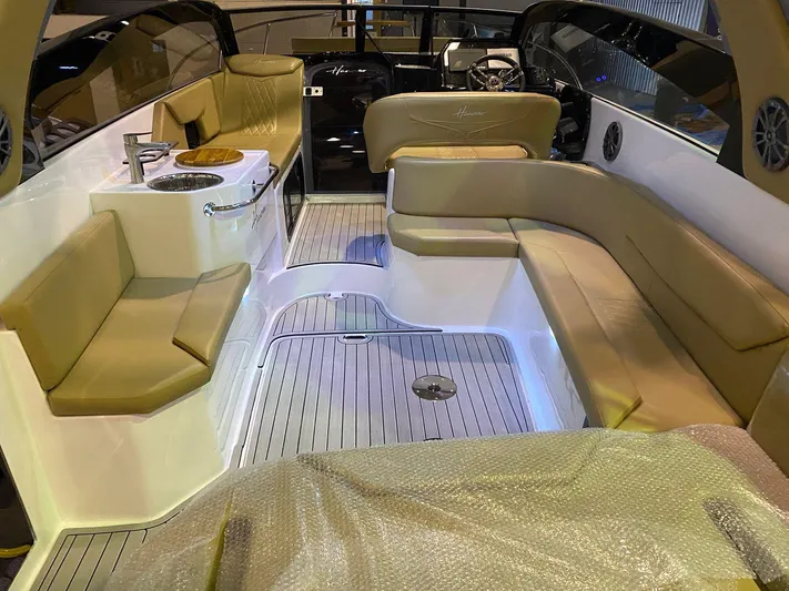  Yacht Photos Pics Luxurious 2024 Hanover 305 boat interior with beige seating and modern amenities.
