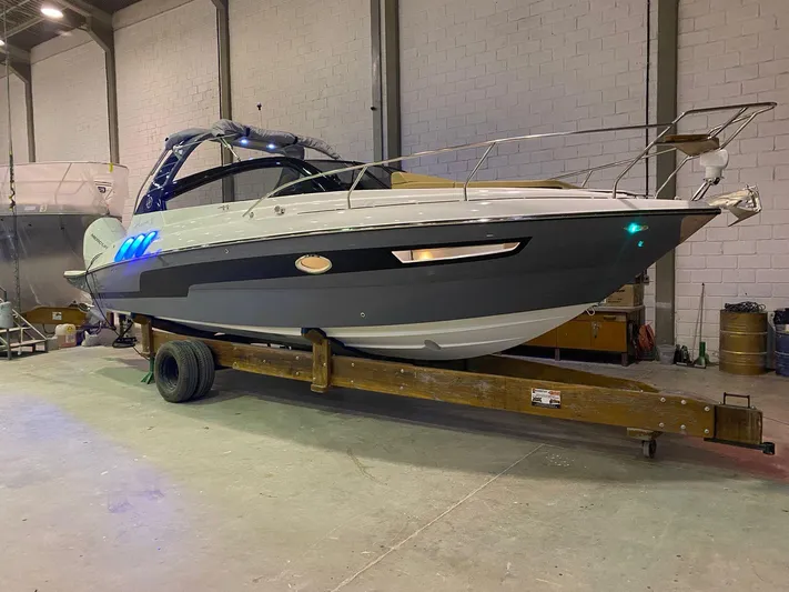  Yacht Photos Pics 2024 Hanover 305 boat in a warehouse on a trailer.