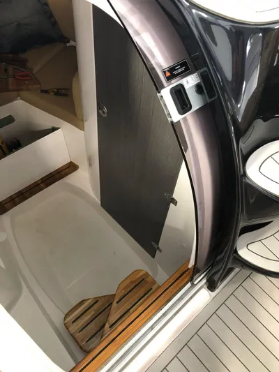  Yacht Photos Pics 2024 Hanover 305 boat interior with sleek design and wooden accents.