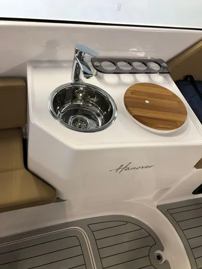  Yacht Photos Pics 2024 Hanover 305 boat sink and cutting board setup with cup holders.