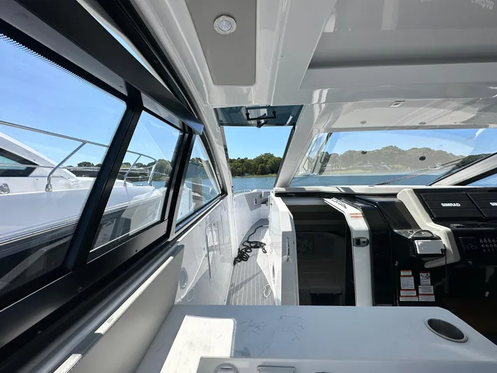  Yacht Photos Pics 2024 Cruisers Yachts 42 GLS Outboard interior with modern helm and seating area.