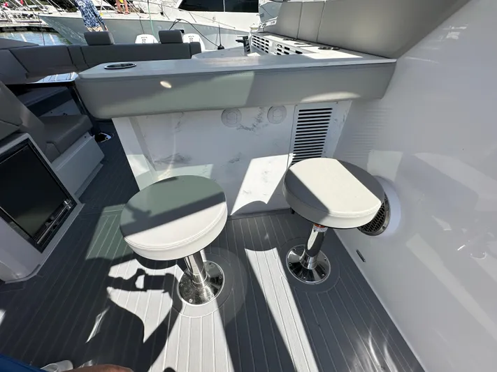  Yacht Photos Pics 2024 Cruisers Yachts 42 GLS Outboard interior with bar stools and seating area.