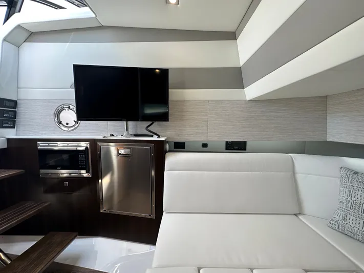  Yacht Photos Pics Interior of 2024 Cruisers Yachts 42 GLS Outboard with TV, microwave, and white seating.