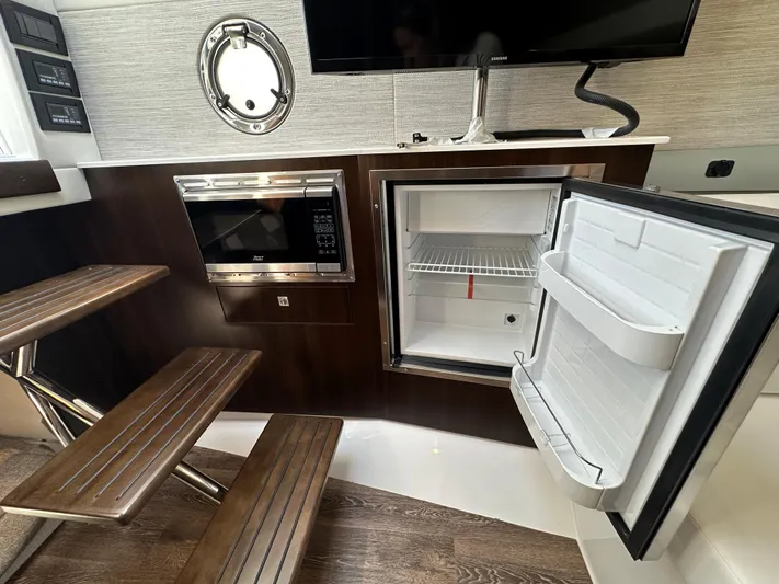  Yacht Photos Pics 2024 Cruisers Yachts 42 GLS Outboard interior with open fridge and microwave.