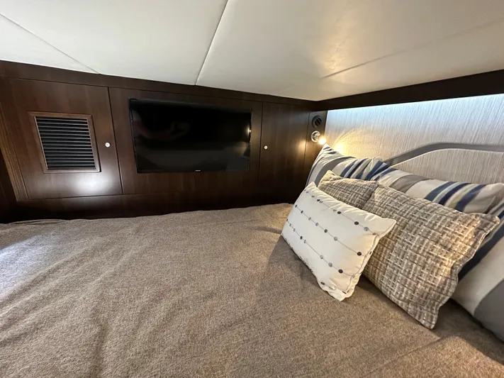  Yacht Photos Pics Luxurious cabin interior of 2024 Cruisers Yachts 42 GLS Outboard with TV and plush bedding.