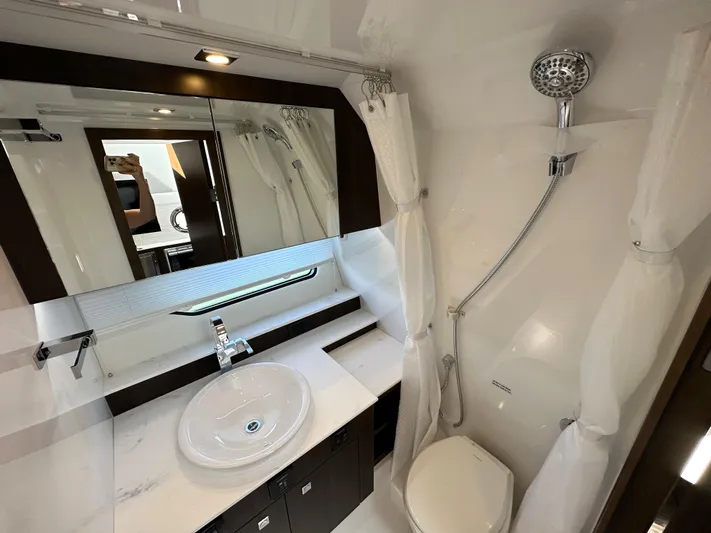  Yacht Photos Pics 2024 Cruisers Yachts 42 GLS Outboard bathroom with modern fixtures and shower.