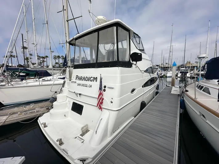 Paradigm Yacht Photos Pics 2004 Carver 366 Motor Yacht docked at marina, rear view with American flag.