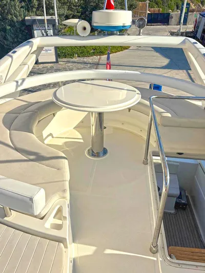  Yacht Photos Pics 2005 Ferretti Yachts 530 flybridge with seating and table, docked in a marina.