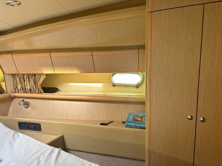  Yacht Photos Pics Interior cabin of 2005 Ferretti Yachts 530 with wood paneling and porthole window.
