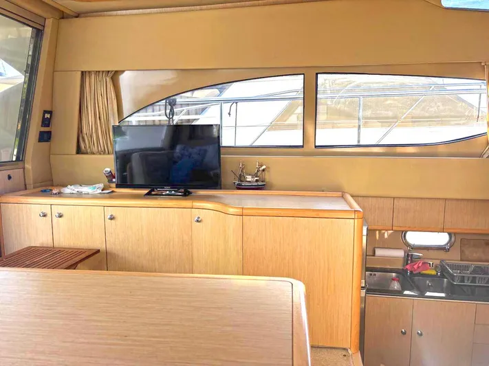  Yacht Photos Pics Luxurious interior of a 2005 Ferretti Yachts 530, featuring a TV and kitchenette.