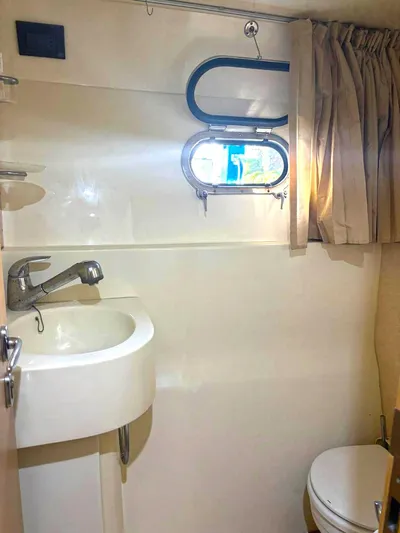  Yacht Photos Pics Bathroom interior of 2005 Ferretti Yachts 530, featuring sink, window, and curtain.