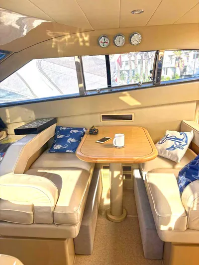  Yacht Photos Pics Interior of 2005 Ferretti Yachts 530 with cozy seating and nautical decor.