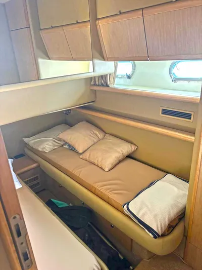  Yacht Photos Pics Cozy cabin interior of 2005 Ferretti Yachts 530 with single bed and storage cabinets.