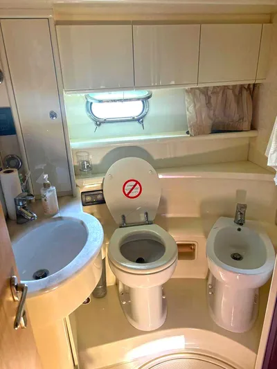  Yacht Photos Pics Bathroom interior of 2005 Ferretti Yachts 530, featuring sink, toilet, and bidet.