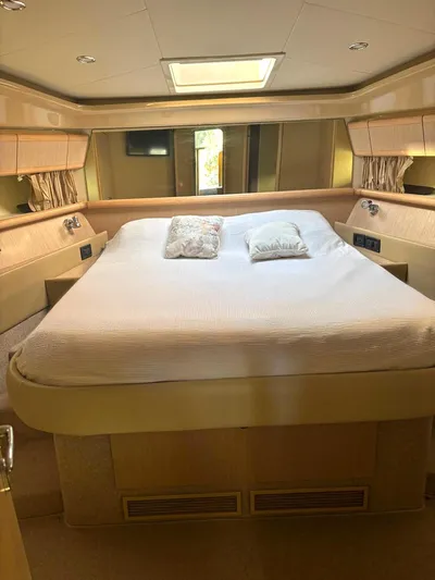  Yacht Photos Pics Luxurious bedroom interior of a 2005 Ferretti Yachts 530, featuring a spacious bed.