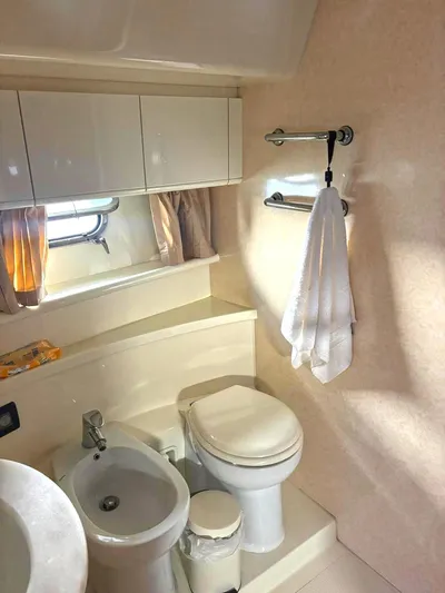  Yacht Photos Pics Bathroom interior of 2005 Ferretti Yachts 530, featuring toilet, bidet, and towel rack.